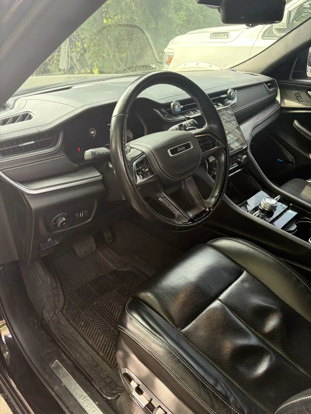 Jeep Grand Cherokee interior before detailing — dirty rubber mats and dull leather